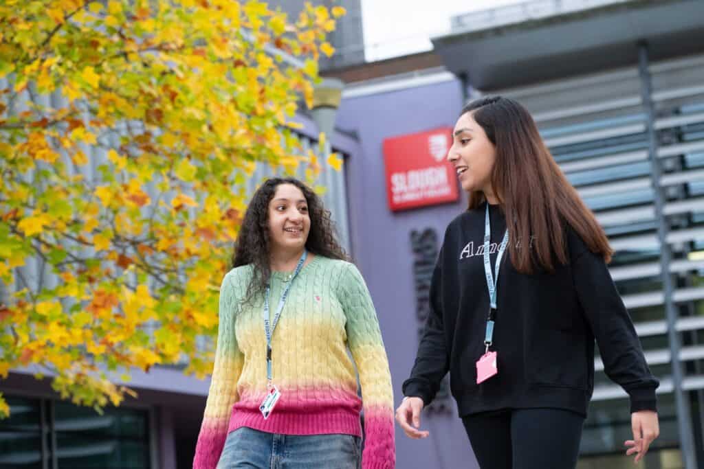2 girls walking away from college