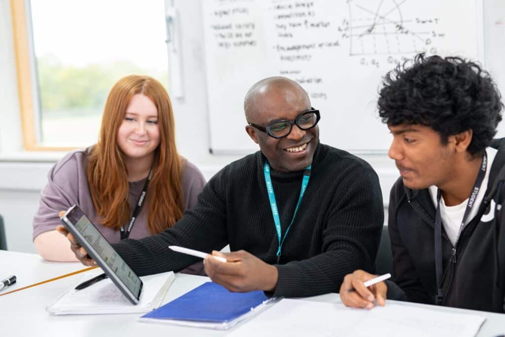 teacher demonstrating with 2 students