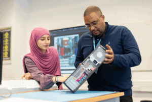 IT student with teacher talking