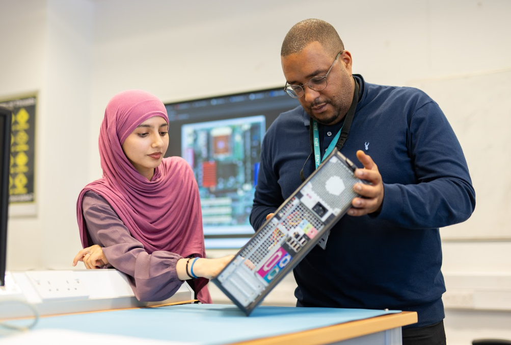 IT student with teacher talking