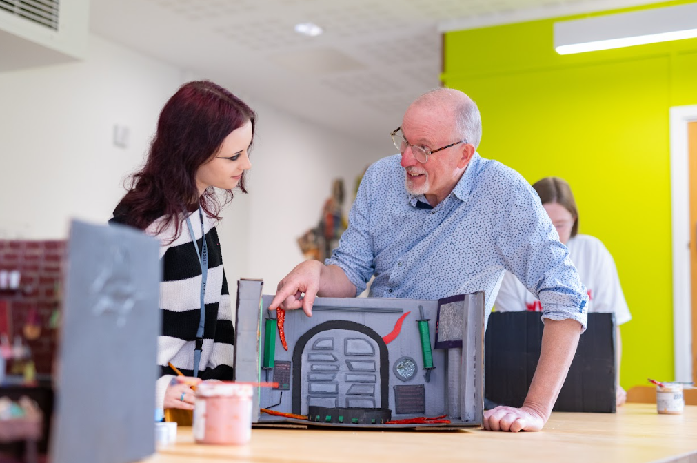 student laughing with teacher