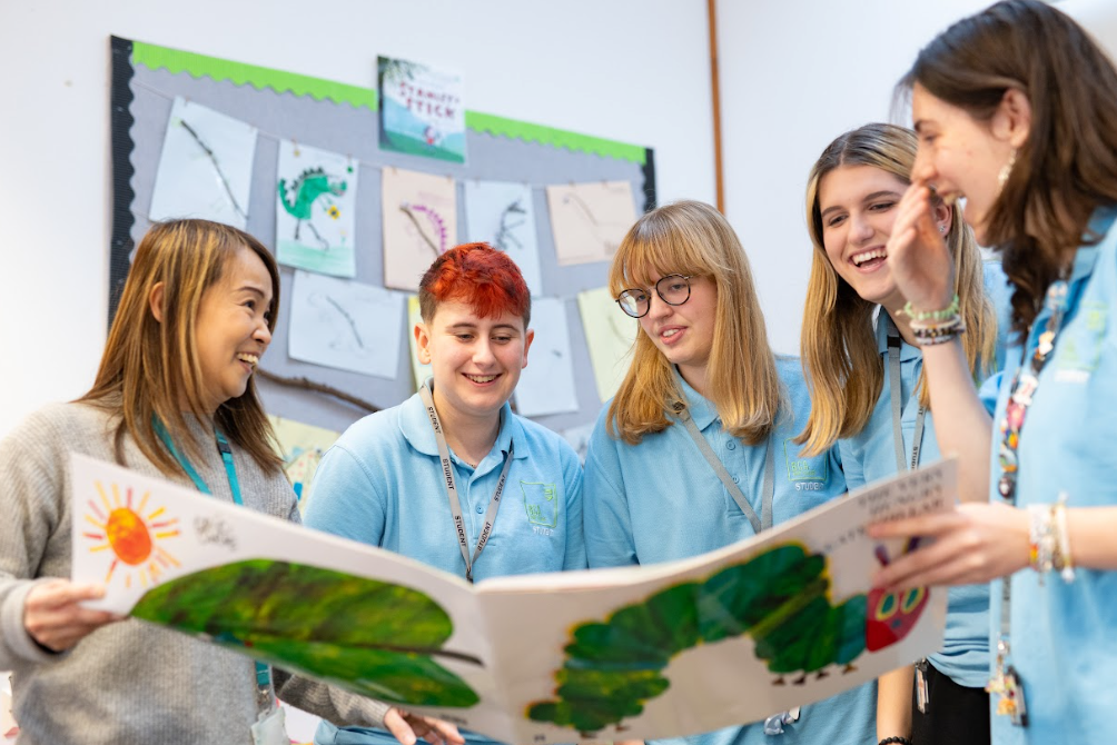 students smiling at a book