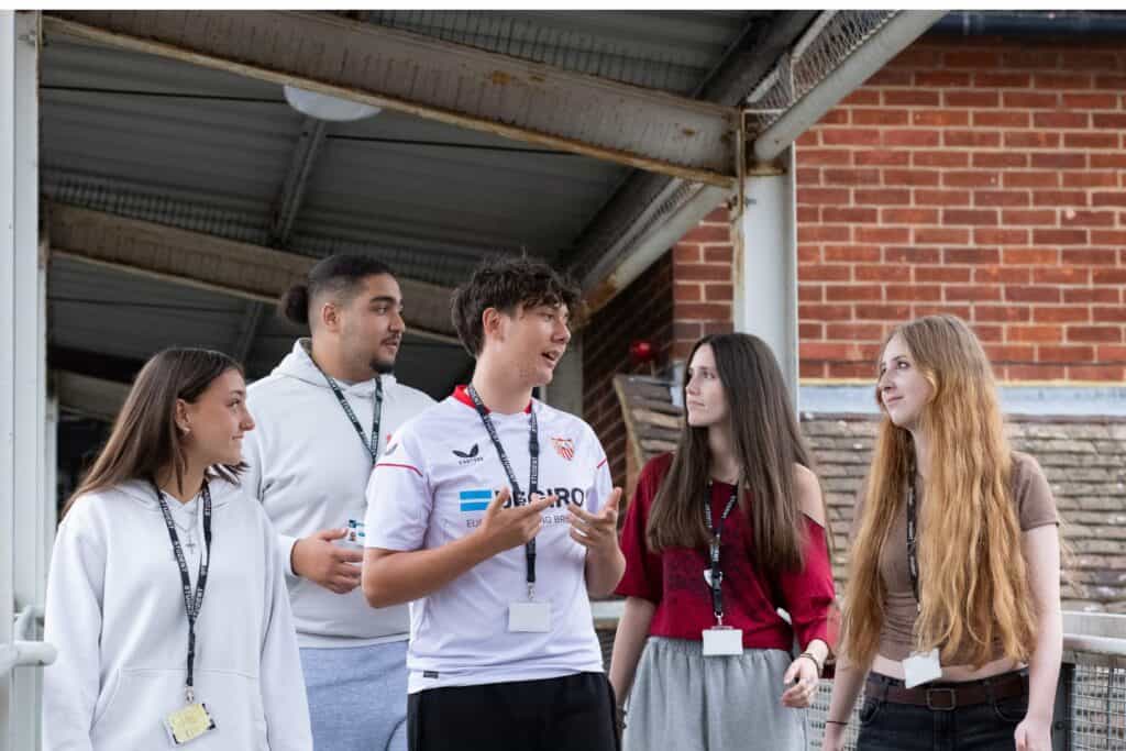 students walking down a corridor laughing