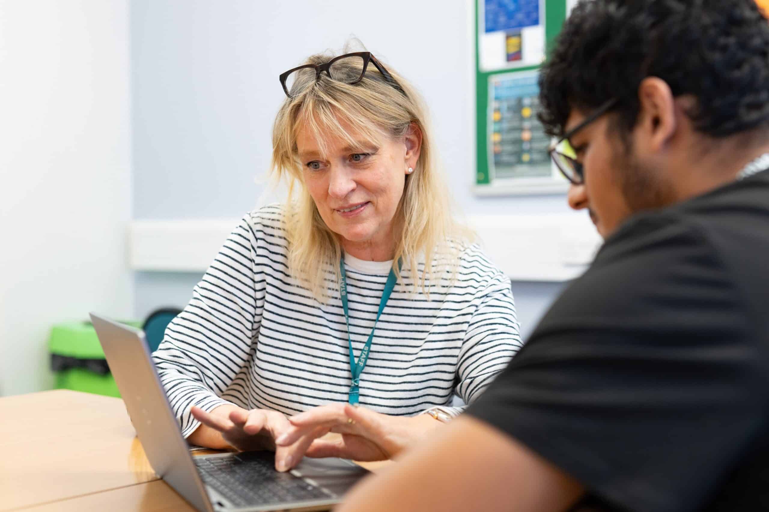 tutor and student looking at computer