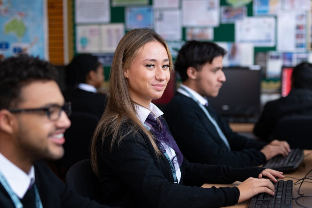 Three travel students with one smiling at camera