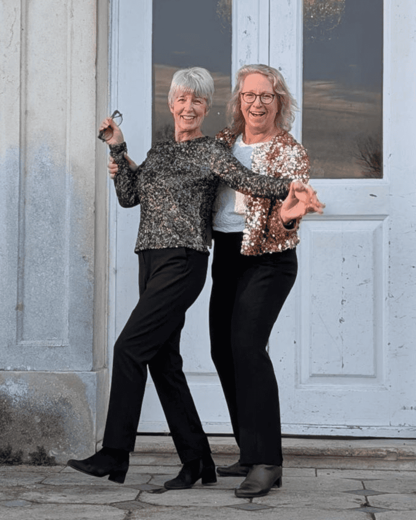 Anne Entwistle and Gillian May on the steps in front of the BCA Mansion