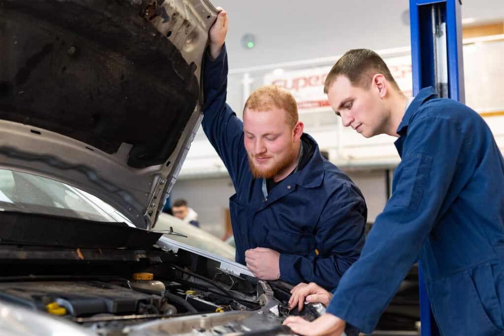 Students working on a car with it's bonnet open