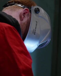An image of a welding student in a helmet