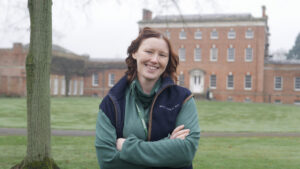 Ami stood arms crossed smiling to camera