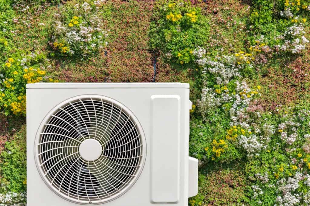 Heat pump surrounded by flowers
