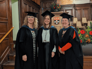 Suzanna, centre, pictured alongside her two course tutors on her graduation day