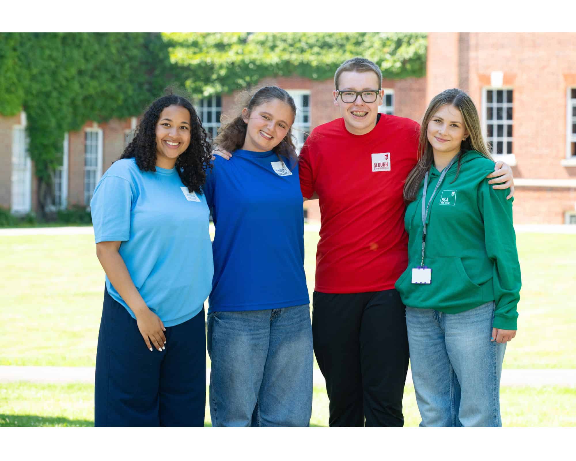 4 students hugging and smiling