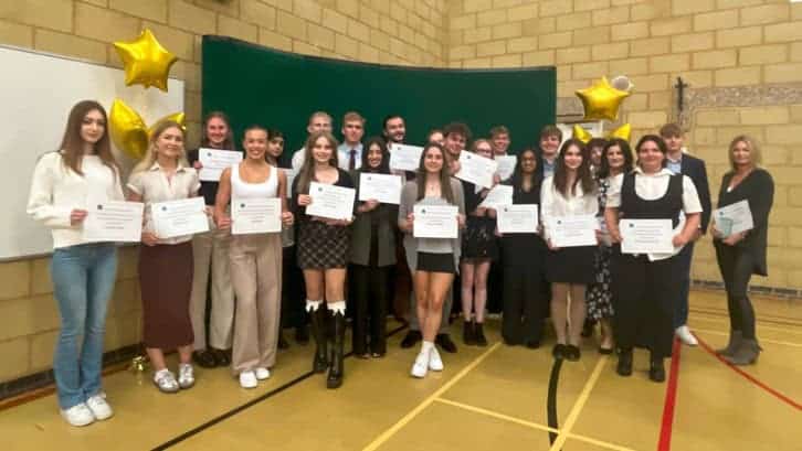 Group photo of award winners with certificates.